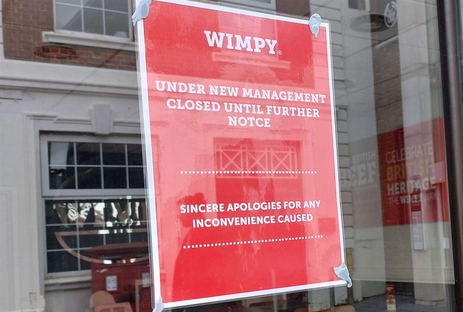 A sign in the window of Ashford’s Wimpy says ‘under new management, closed until further notice’