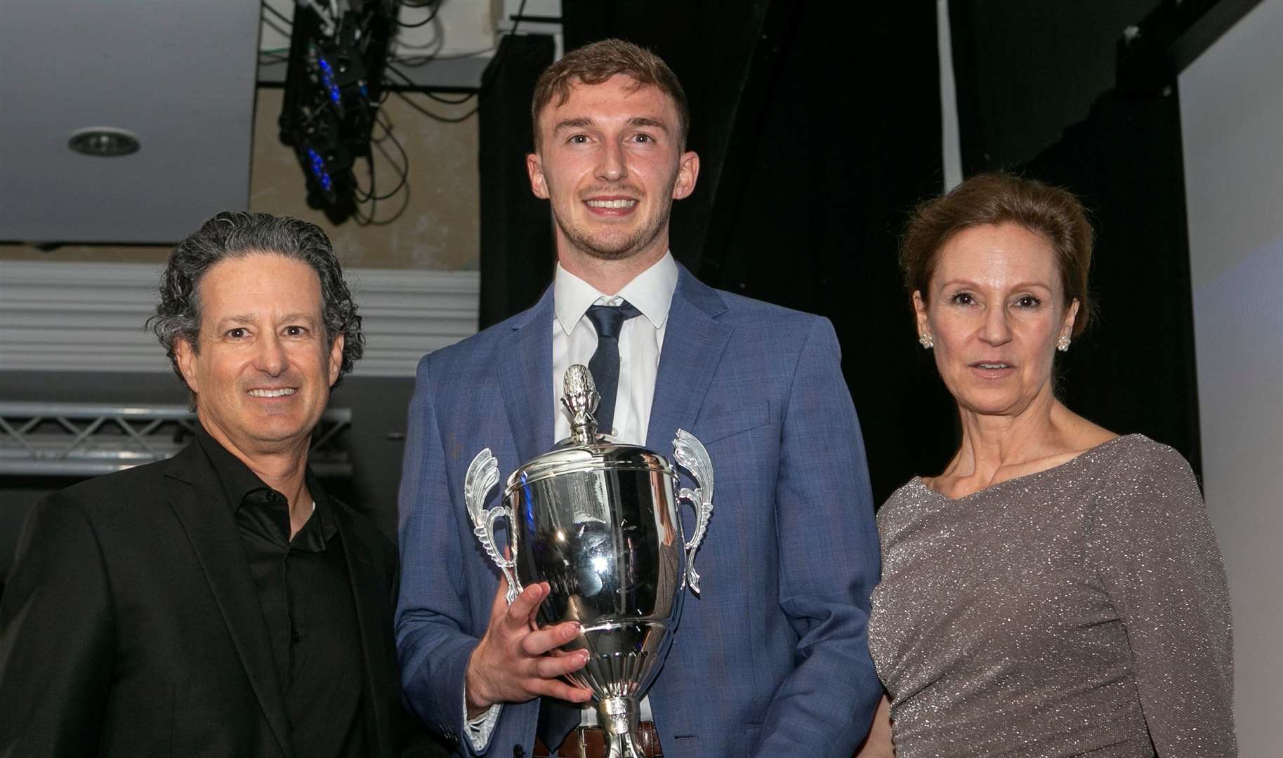 Gillingham's player-of-the-year Conor Masterson with owners Brad and Shannon Galinson